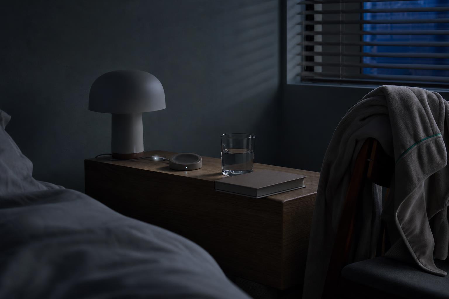 A bedside scene at night, without a sleeper or a screen to read.